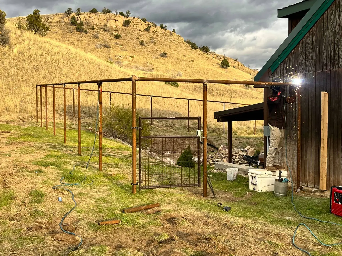 Tall deer fence protecting a garden area on a Montana property
