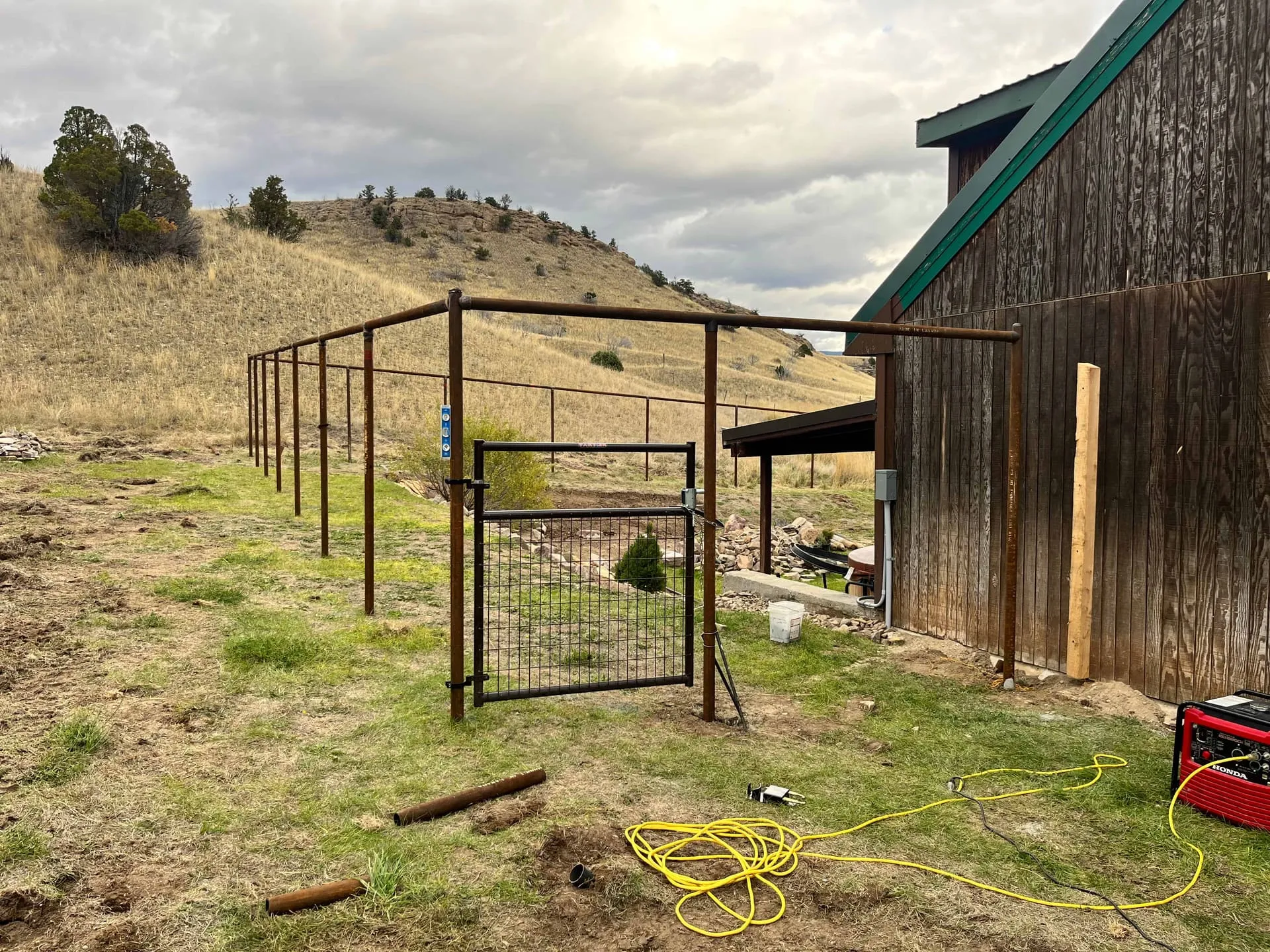 Tall mesh fence protecting a garden area