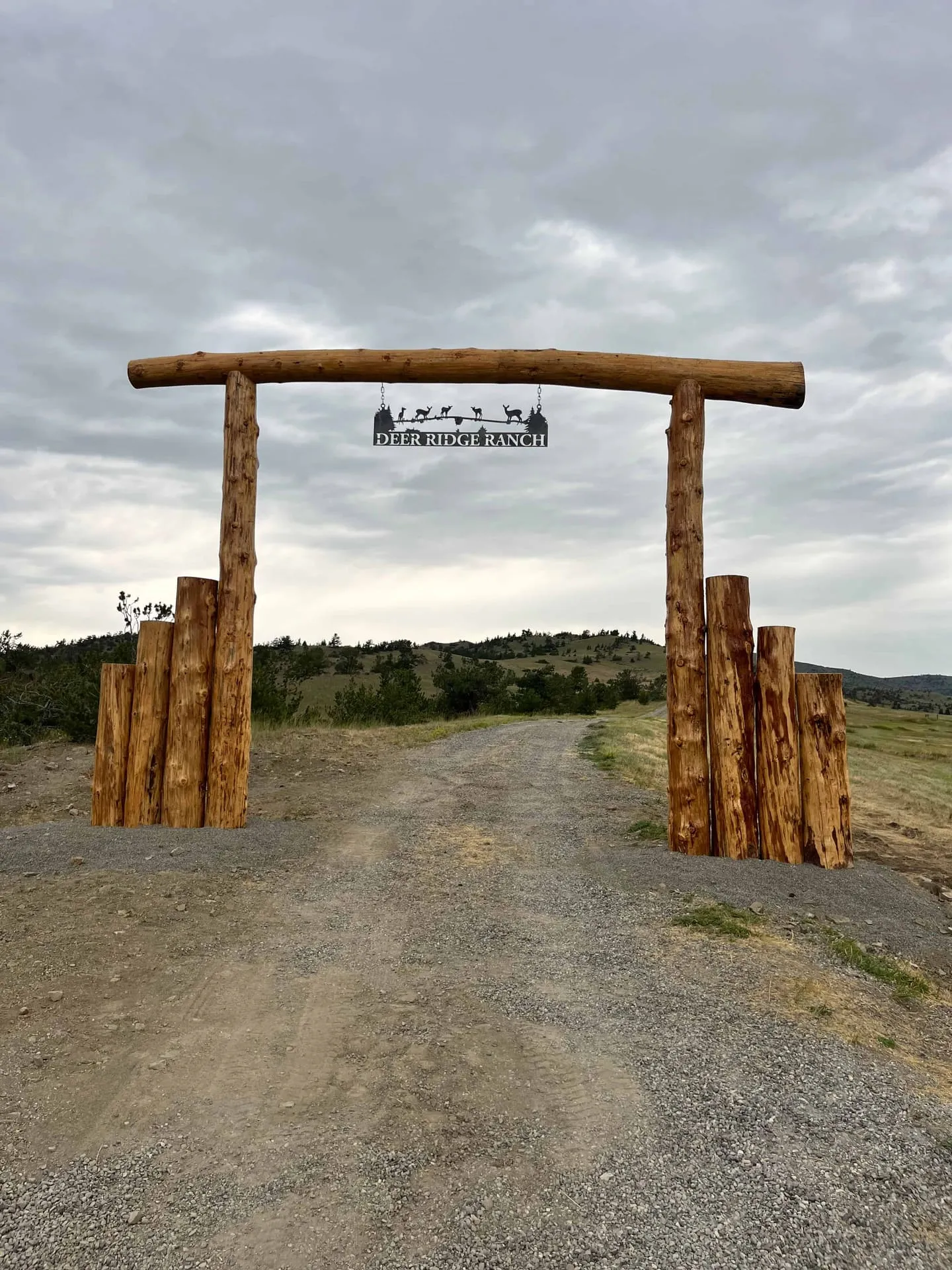 Timber archway with stone accents at a ranch entrance