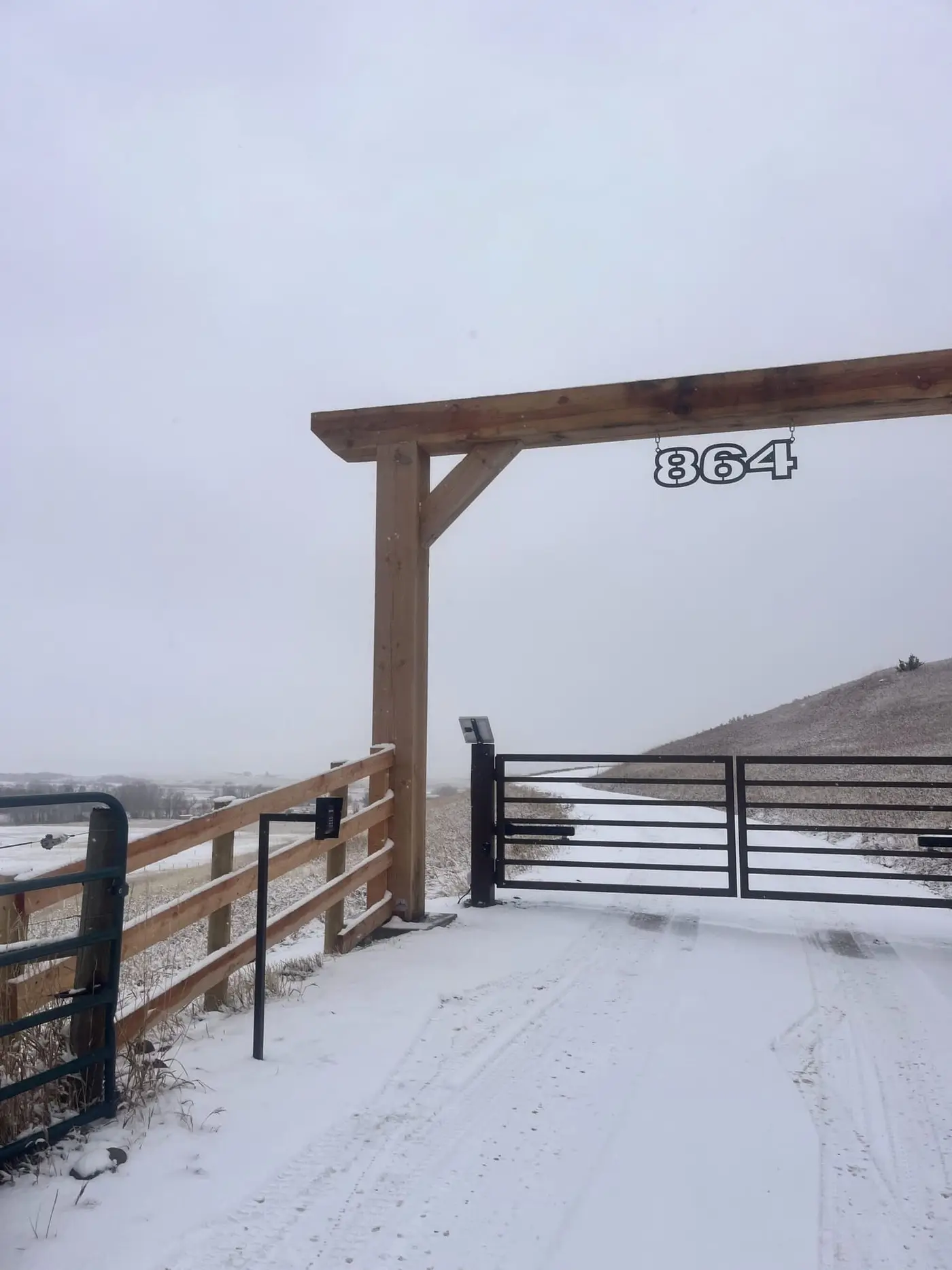 Automatic entry gate and timber archway at a Montana ranch entrance