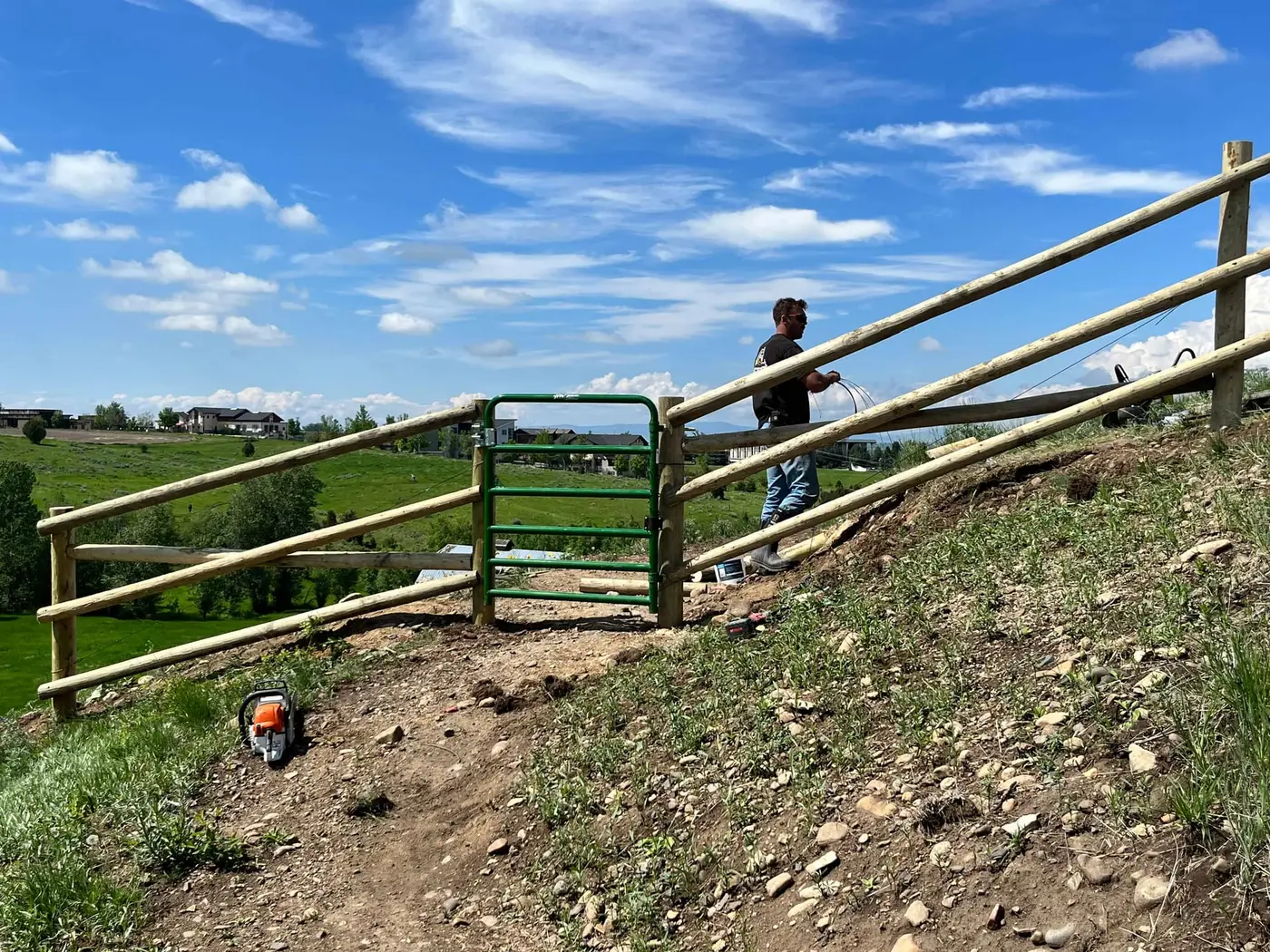 Full round rail fence with doweled posts on a Montana property