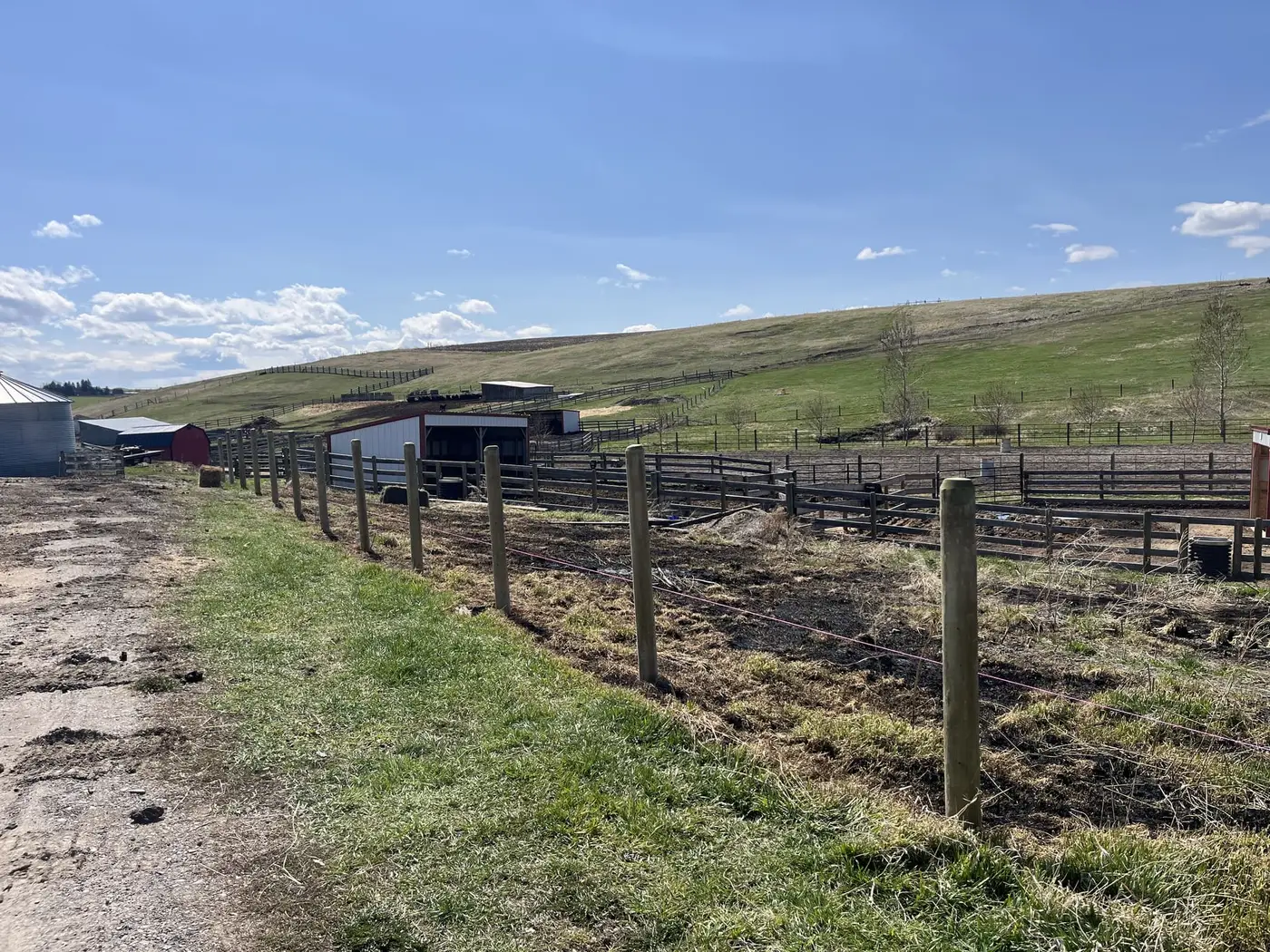 Fence posts being driven into the ground on a Montana ranch