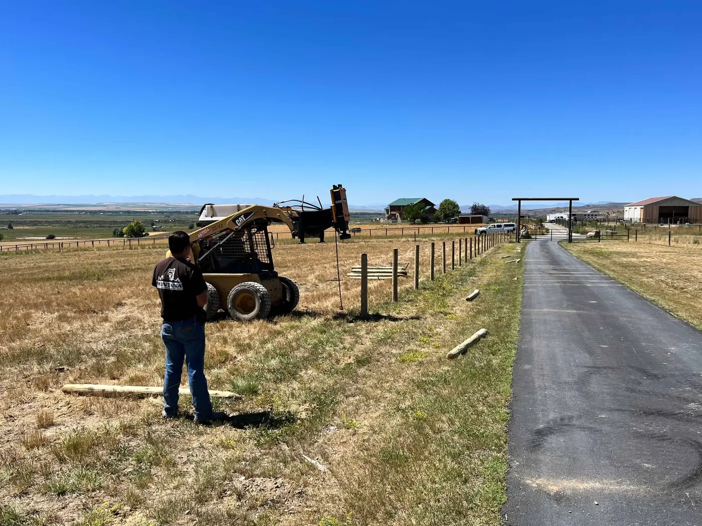 Fence posts driven in a straight line for a new field fence
